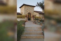 look up at door to home with cottage cream traditional thin veneer installed on the exterior