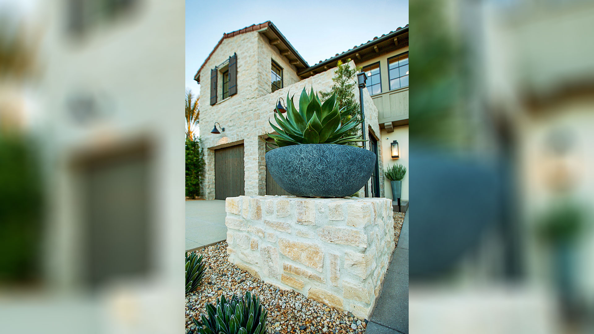 Rhinestone Rubble thin veneer installed on exterior walls and retaining walls with planted succulents