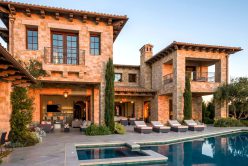 modern home pool deck with sunset reflecting off the Tuscan Blend Rubble thin veneer exterior walls