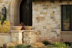close up of door to home with cottage cream traditional thin veneer installed on exterior of home
