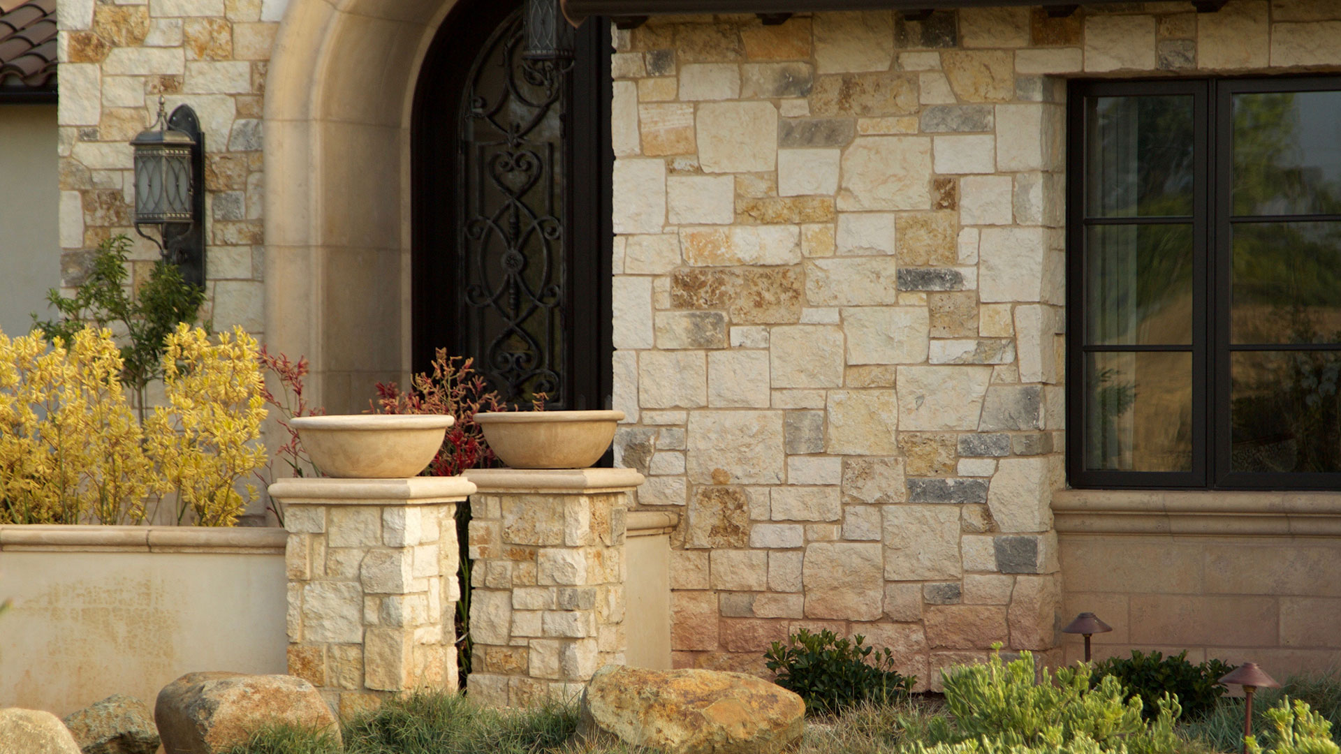 close up of door to home with cottage cream traditional thin veneer installed on exterior of home