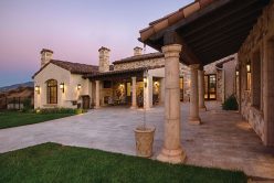 home at sunset with moon in the distance with Cottage Cream Traditional thin veneer installed on exterior walls