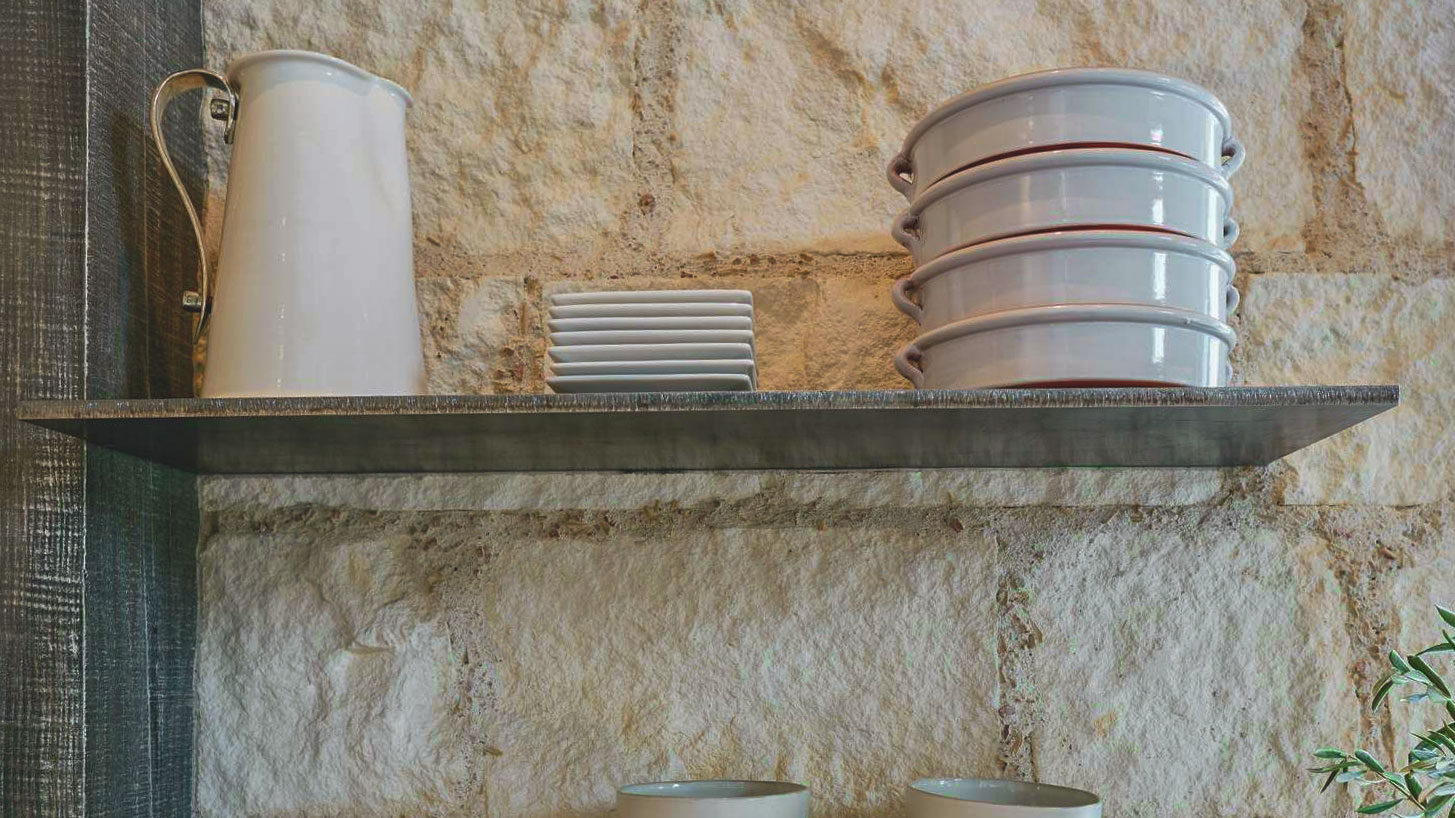 floating shelfs on interior kitchen wall installed with cream traditional thin veneer