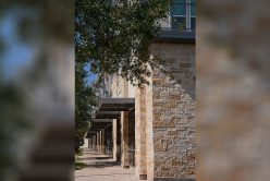 side walk with building on the right with montgomery gold thin veneer installed on exterior walls