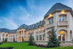 custom build home with cream custom architectural cut stone installed on exterior of home.