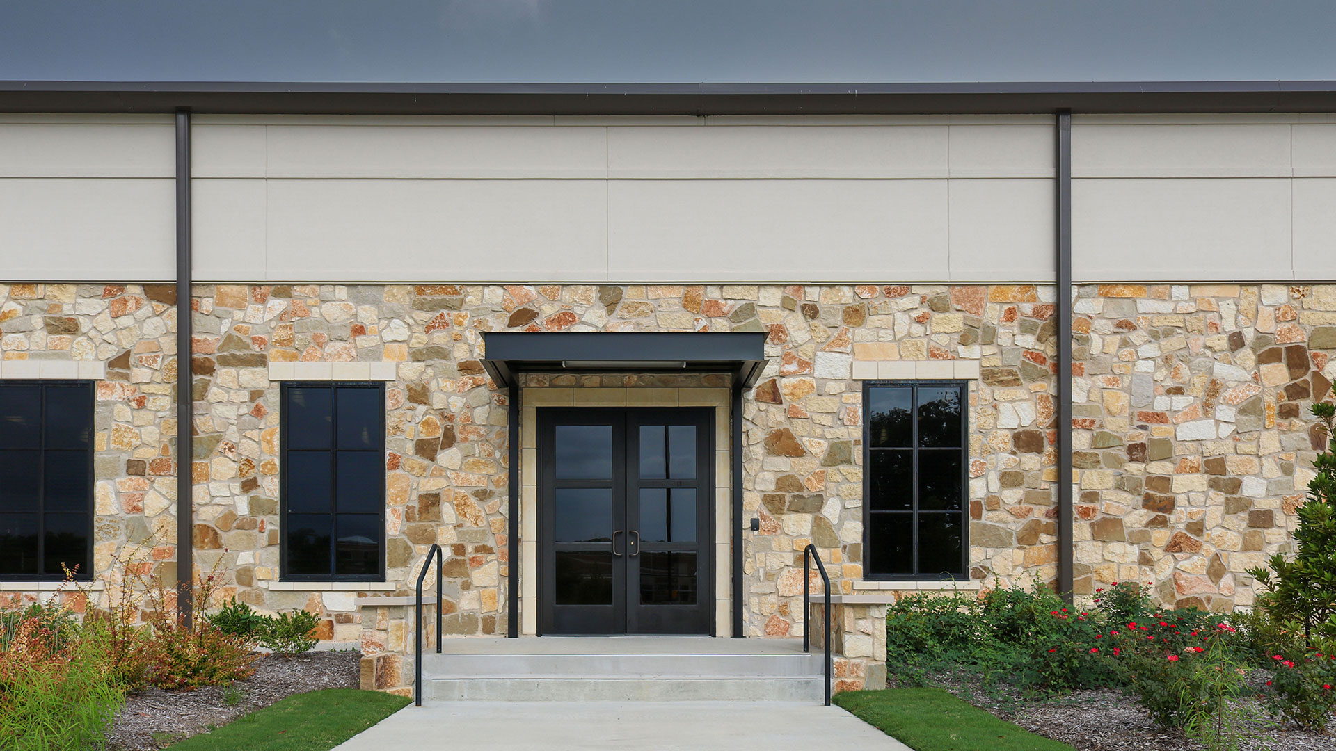 exterior of building with fassati blend rubble custom profile installed on exterior walls