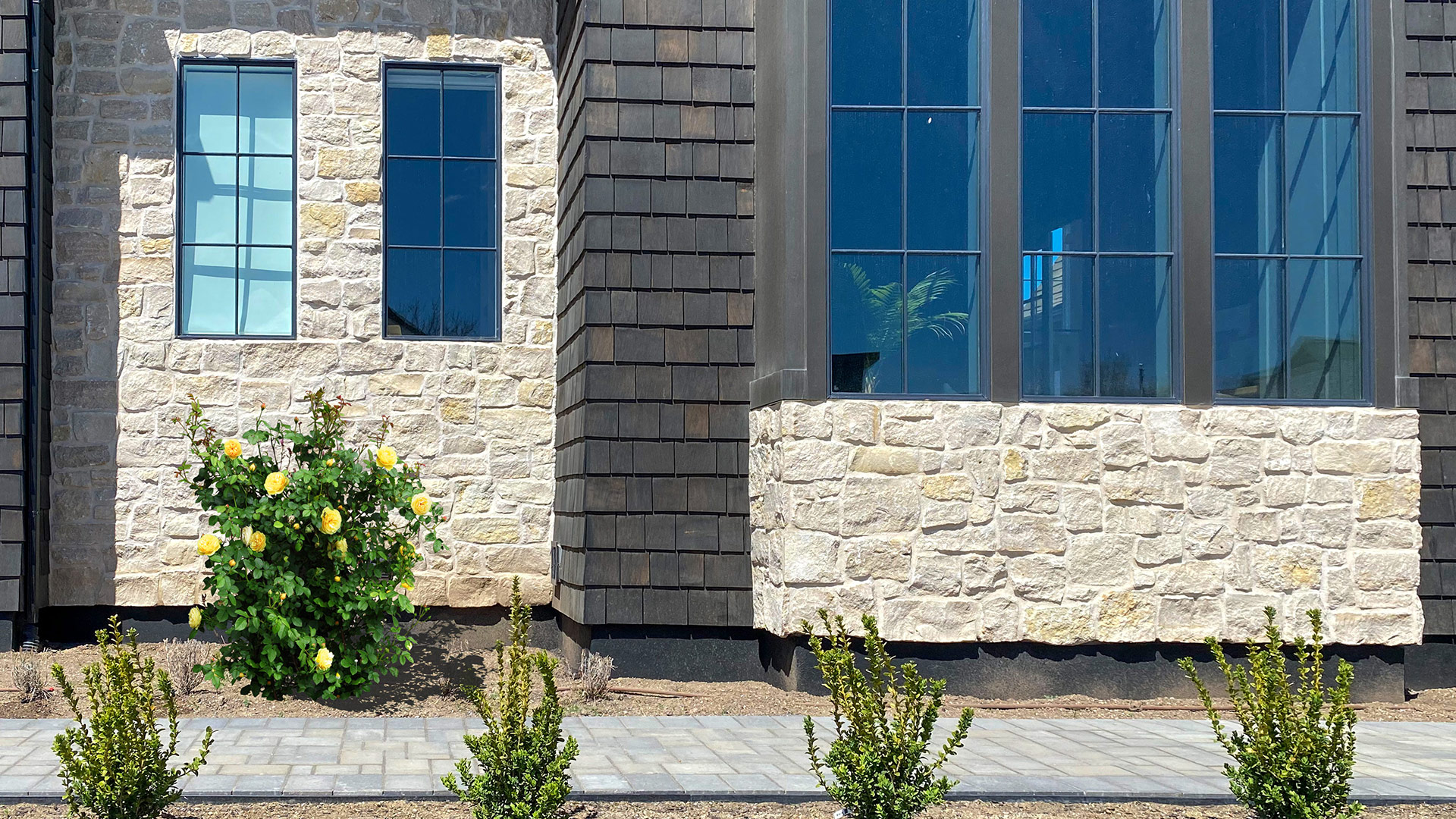Tundra Cream Rubble natural stone thin veneer installed on exterior of custom home.