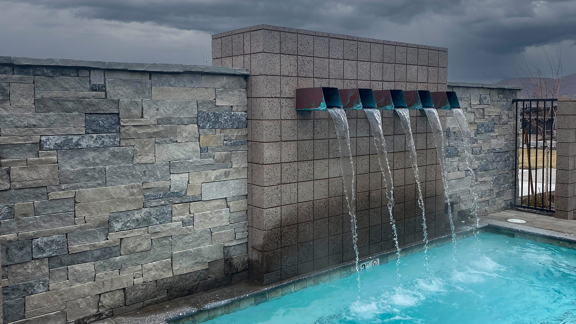 Mission Blue Traditional natural stone thin veneer installed on exterior walls of commercial building.