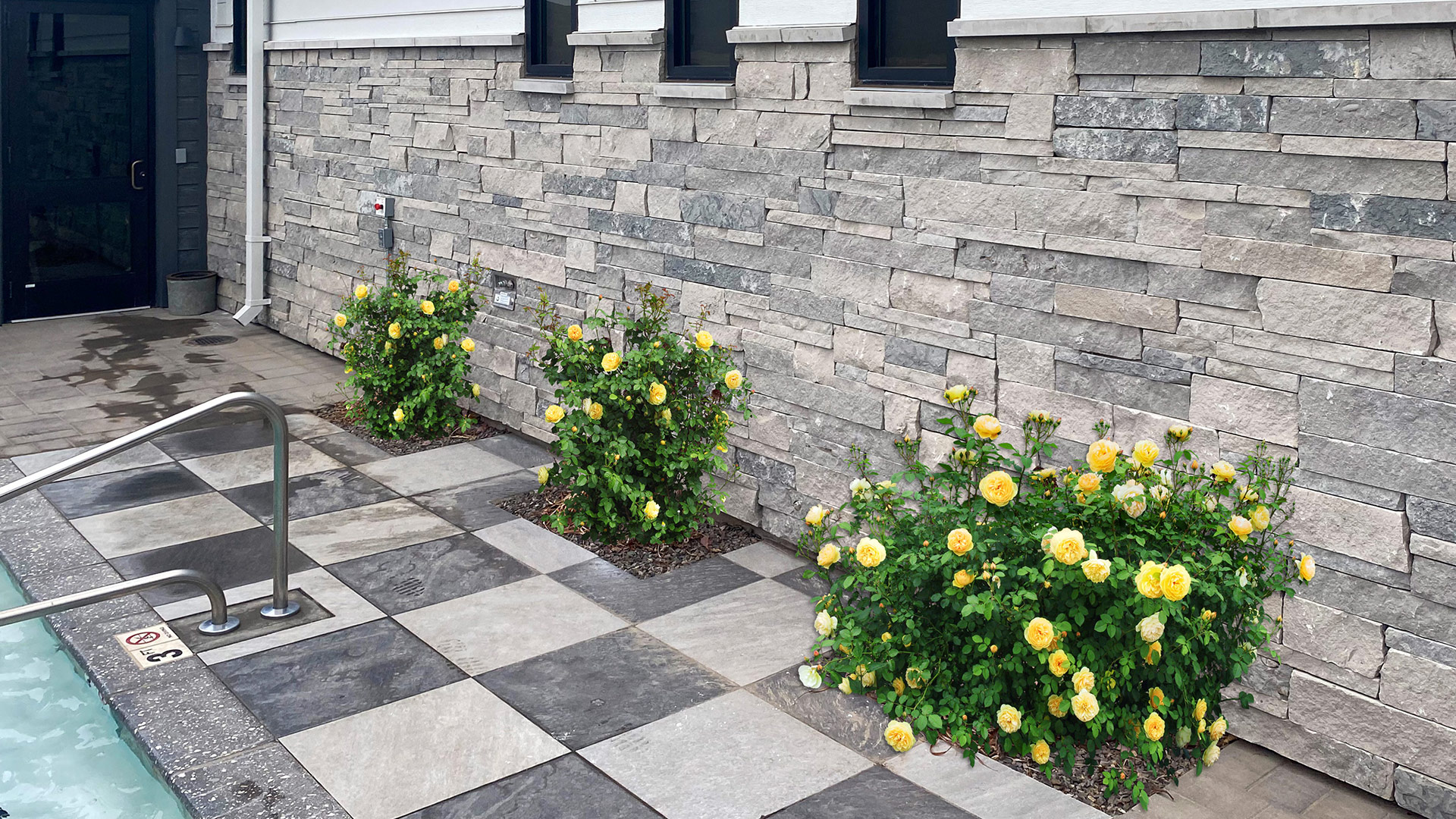 Mission Blue Traditional natural stone thin veneer installed on exterior walls of commercial building.